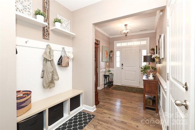 mudroom featuring crown molding, hardwood / wood-style floors, and an inviting chandelier