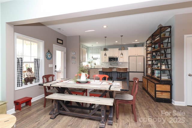 dining area with hardwood / wood-style floors