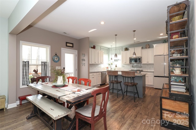 dining area featuring dark wood-type flooring