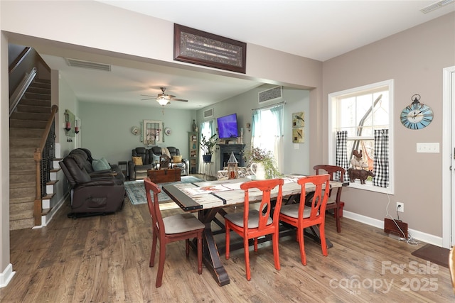 dining area with hardwood / wood-style flooring and ceiling fan