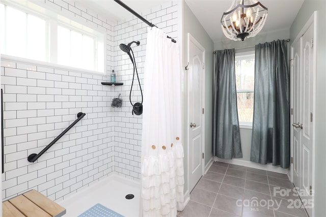 bathroom with walk in shower, tile patterned floors, and a chandelier