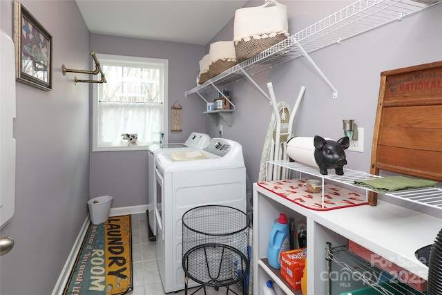 laundry area with washer and dryer and light tile patterned flooring