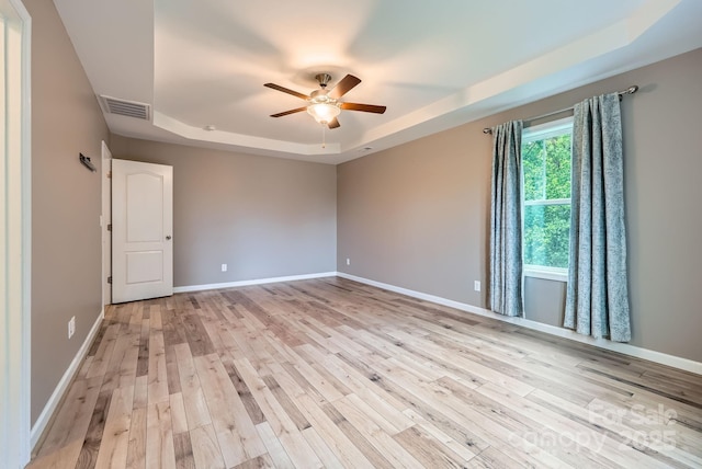 2864 Park Ridge Blvd, Rock Hill, SC 29732 - spare room featuring a tray ceiling, light wood-type flooring, a ceiling fan, and baseboards