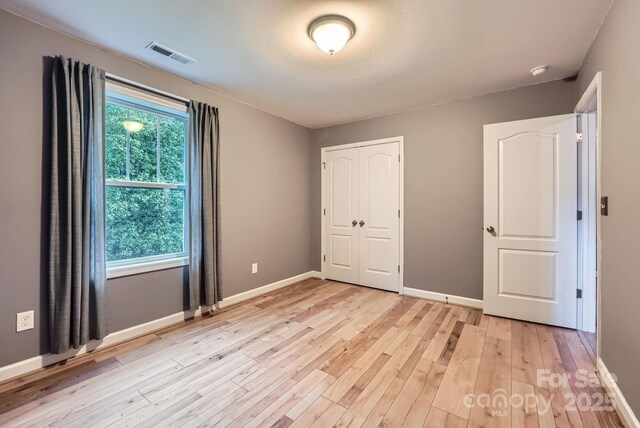 2864 Park Ridge Blvd, Rock Hill, SC 29732 - unfurnished bedroom with light wood-type flooring, baseboards, and a closet