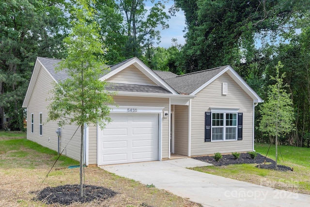 single story home featuring a garage and a front yard