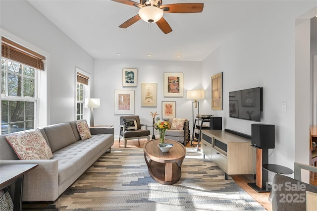 living room with hardwood / wood-style floors and ceiling fan