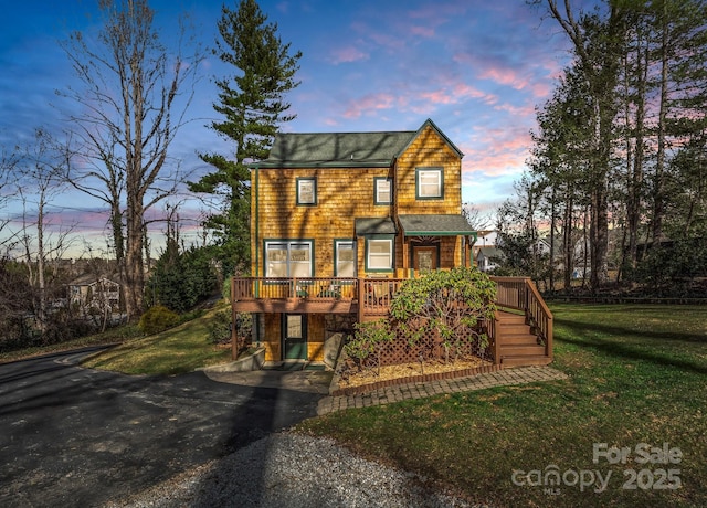 view of front facade featuring a deck and a lawn