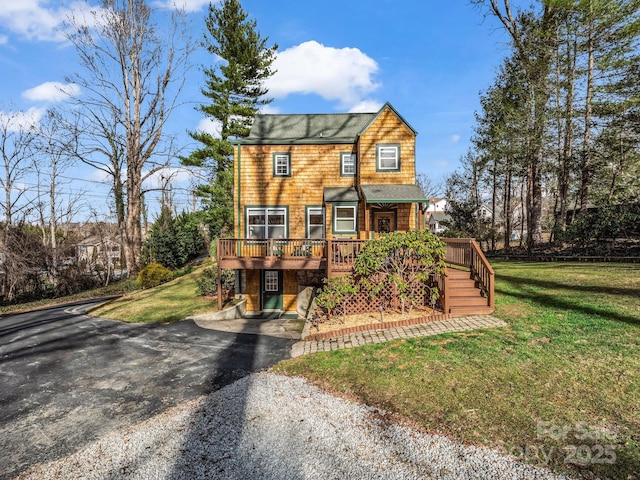 view of front of house with a wooden deck and a front yard