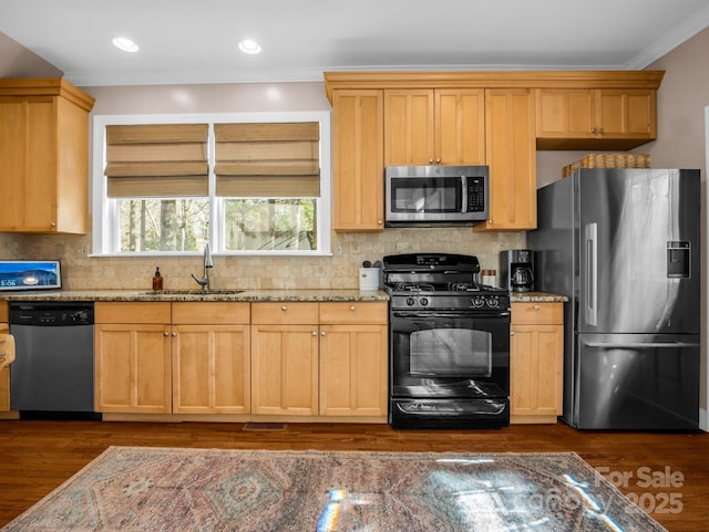 kitchen featuring sink, crown molding, stainless steel appliances, dark hardwood / wood-style floors, and light stone counters