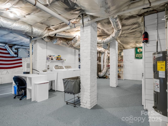 basement featuring washer and clothes dryer, sink, and water heater