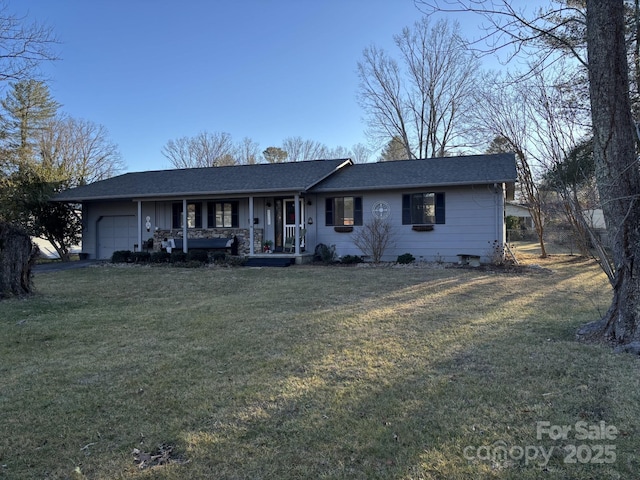 single story home featuring a garage, a front yard, and covered porch