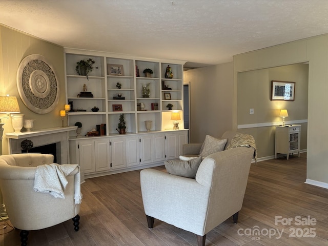 living room with hardwood / wood-style flooring and a textured ceiling