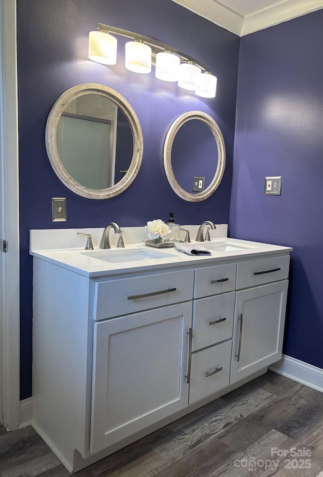 bathroom featuring vanity, ornamental molding, and hardwood / wood-style floors