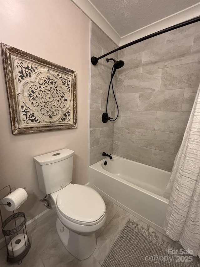 bathroom with shower / tub combo with curtain, toilet, and a textured ceiling