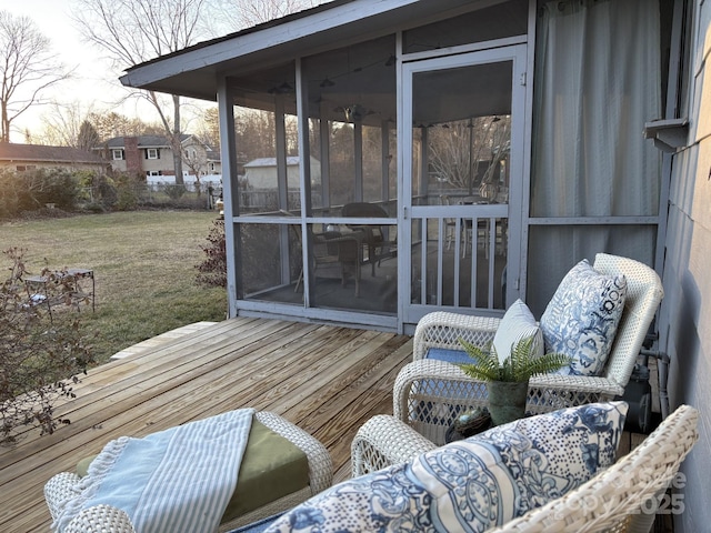 wooden deck with a sunroom and a yard