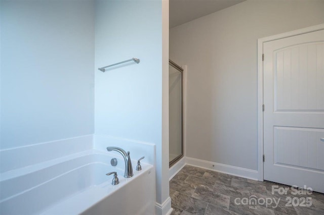 bathroom featuring shower with separate bathtub