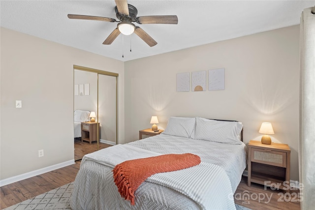 bedroom featuring hardwood / wood-style floors, ceiling fan, and a closet