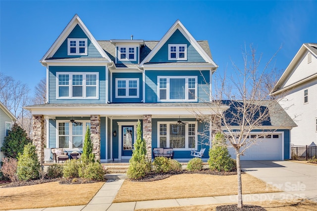 view of front of property featuring ceiling fan, a garage, and covered porch