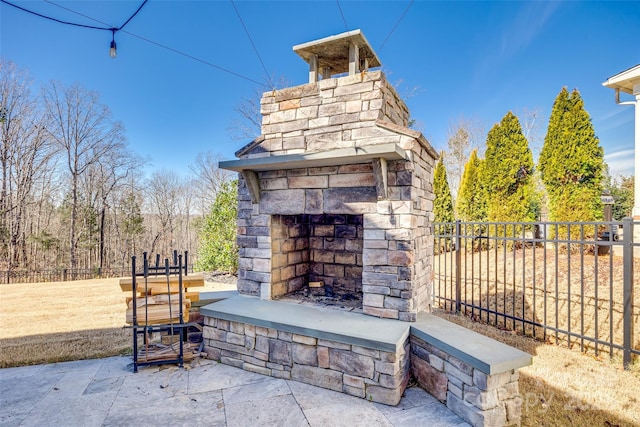 view of patio featuring an outdoor stone fireplace