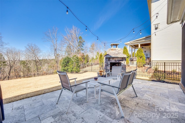 view of patio / terrace featuring an outdoor stone fireplace