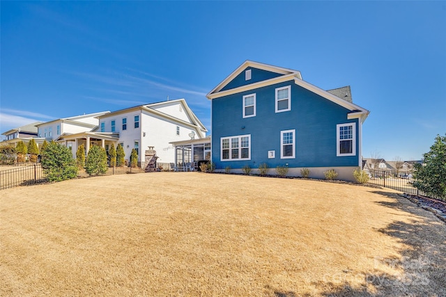 rear view of house featuring a yard