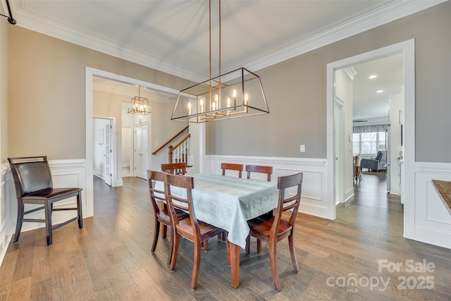 dining area with ornamental molding and hardwood / wood-style floors