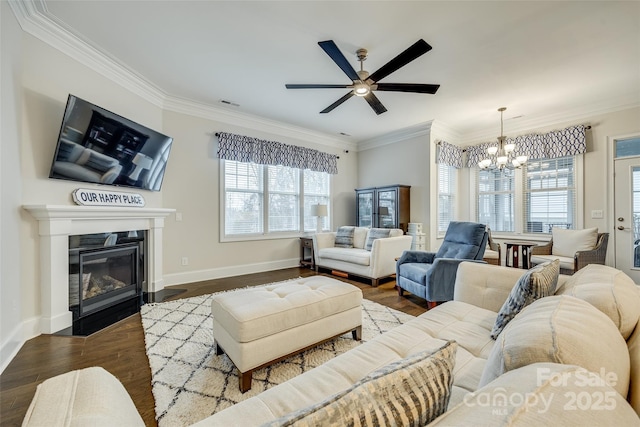 living room with crown molding, plenty of natural light, and dark hardwood / wood-style floors