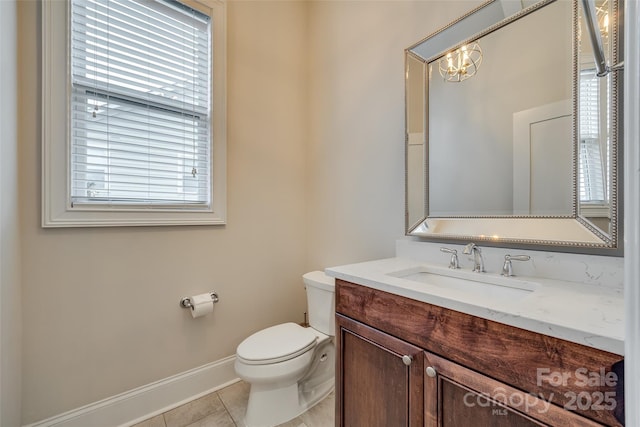 bathroom with vanity, tile patterned flooring, and toilet