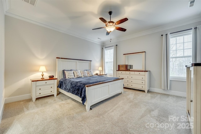 carpeted bedroom with ornamental molding and ceiling fan