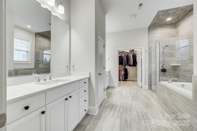 bathroom with shower with separate bathtub and vanity