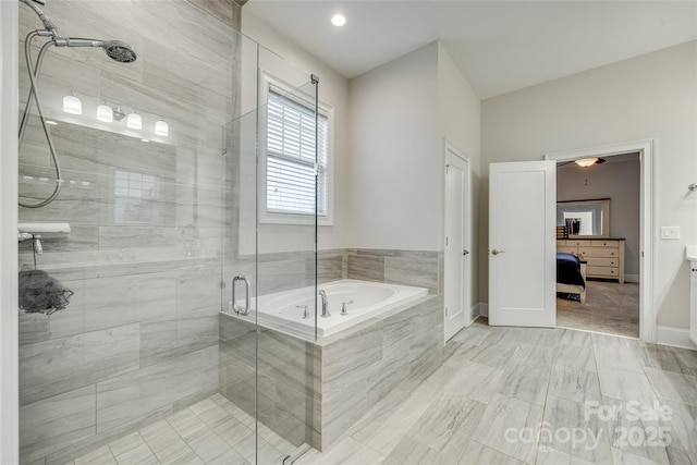 bathroom with vanity and shower with separate bathtub