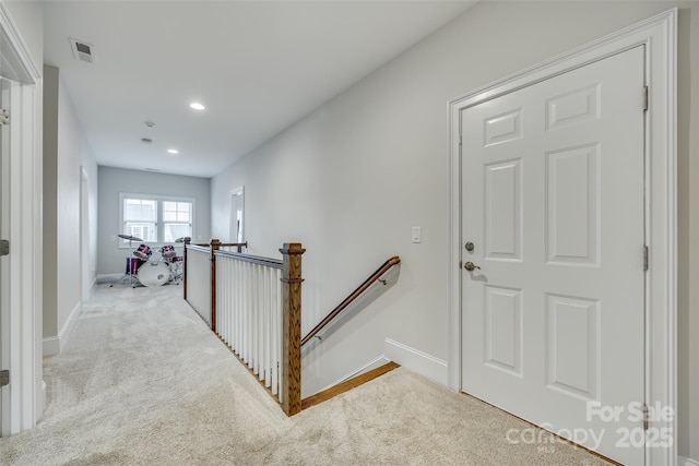 hallway featuring light carpet