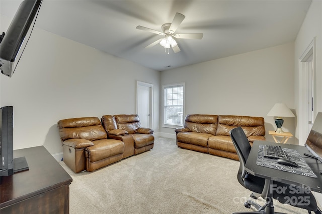 carpeted home office featuring ceiling fan