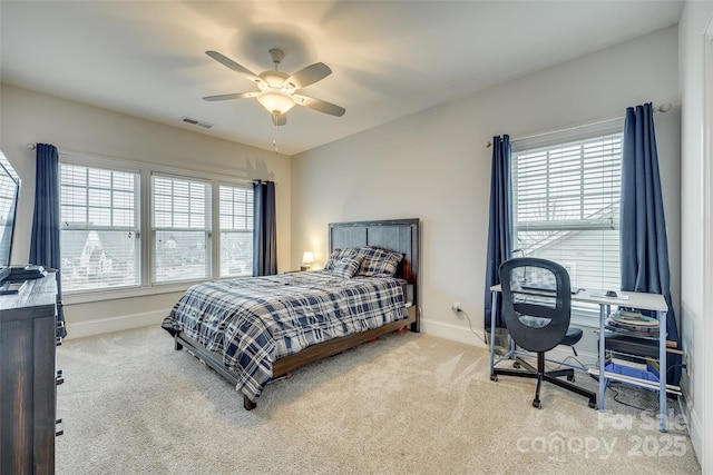 bedroom with ceiling fan and light colored carpet