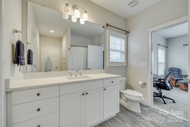 bathroom with vanity and toilet