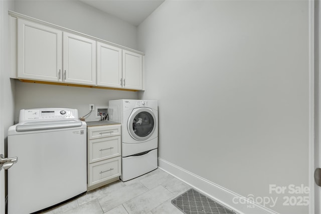 clothes washing area with independent washer and dryer and cabinets