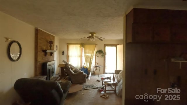 miscellaneous room with a large fireplace, a textured ceiling, and ceiling fan