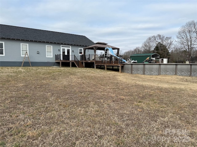 back of property with a yard and a gazebo