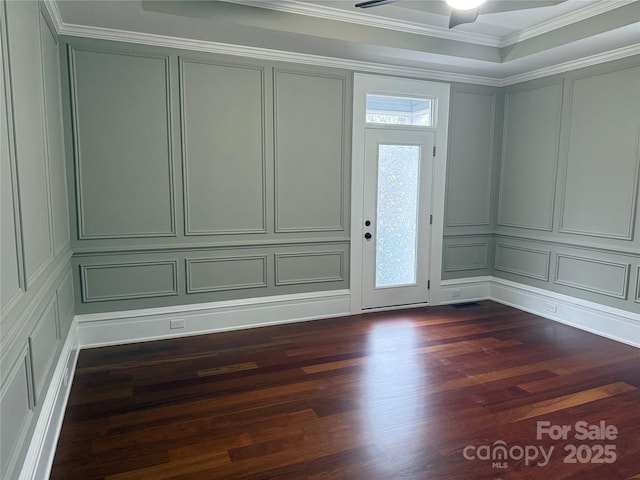 entryway with dark wood-type flooring, ceiling fan, and crown molding