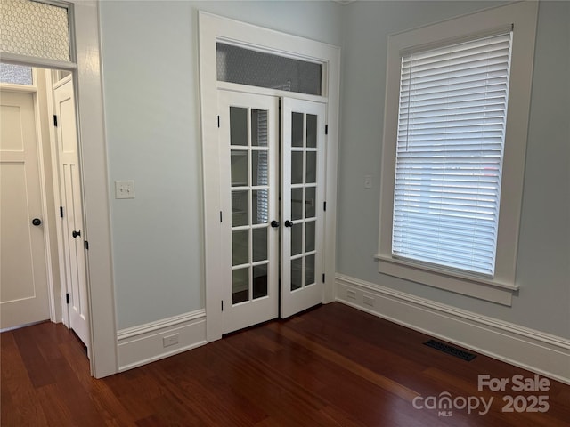 doorway to outside with dark wood-type flooring and french doors