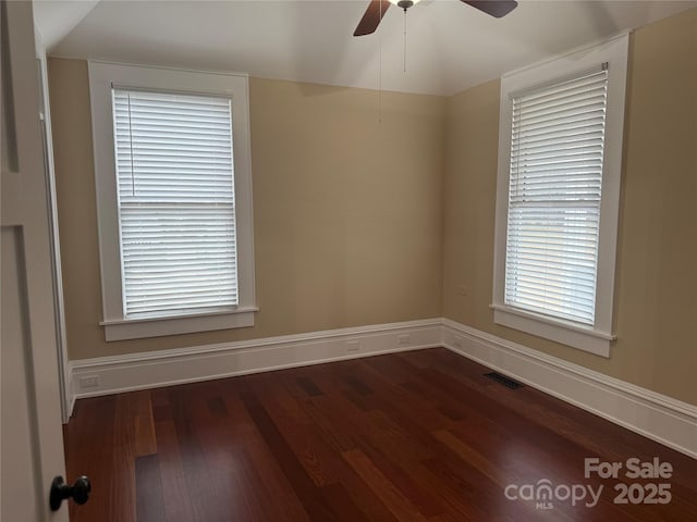 spare room featuring ceiling fan, lofted ceiling, and dark hardwood / wood-style flooring