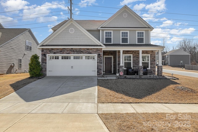 craftsman house featuring a porch, stone siding, driveway, and an attached garage