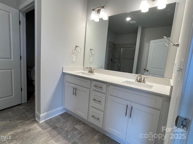 bathroom with vanity and a shower with door