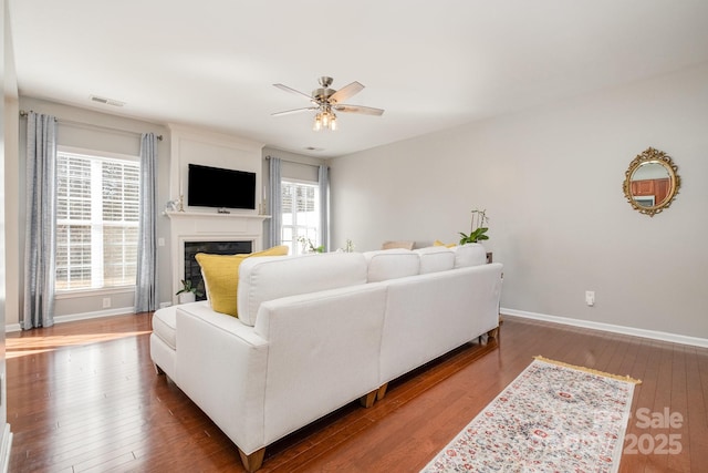 living room with hardwood / wood-style flooring, ceiling fan, and a healthy amount of sunlight