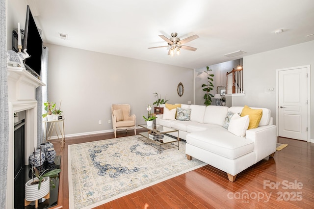 living room featuring wood-type flooring and ceiling fan