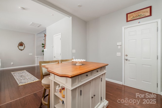 dining space featuring dark wood-type flooring