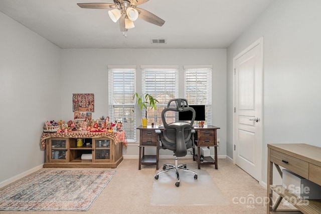 carpeted office space with ceiling fan