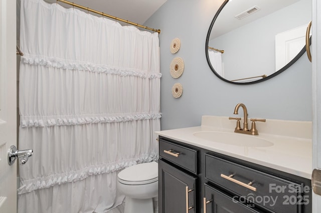 bathroom featuring vanity, toilet, and a shower with shower curtain