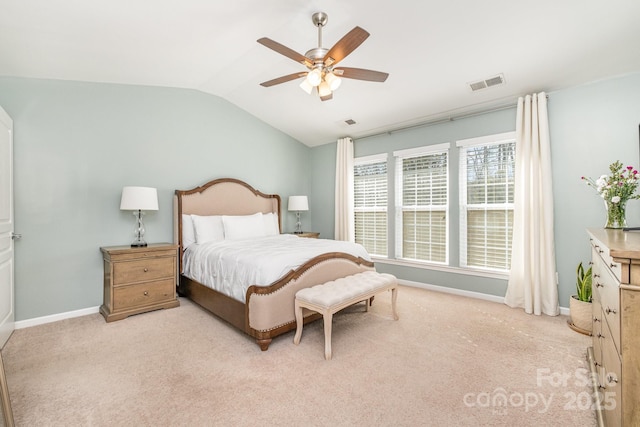 carpeted bedroom with vaulted ceiling and ceiling fan