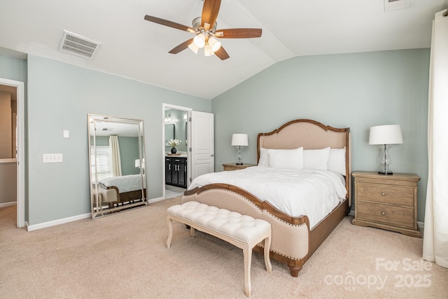 carpeted bedroom with connected bathroom, vaulted ceiling, and ceiling fan